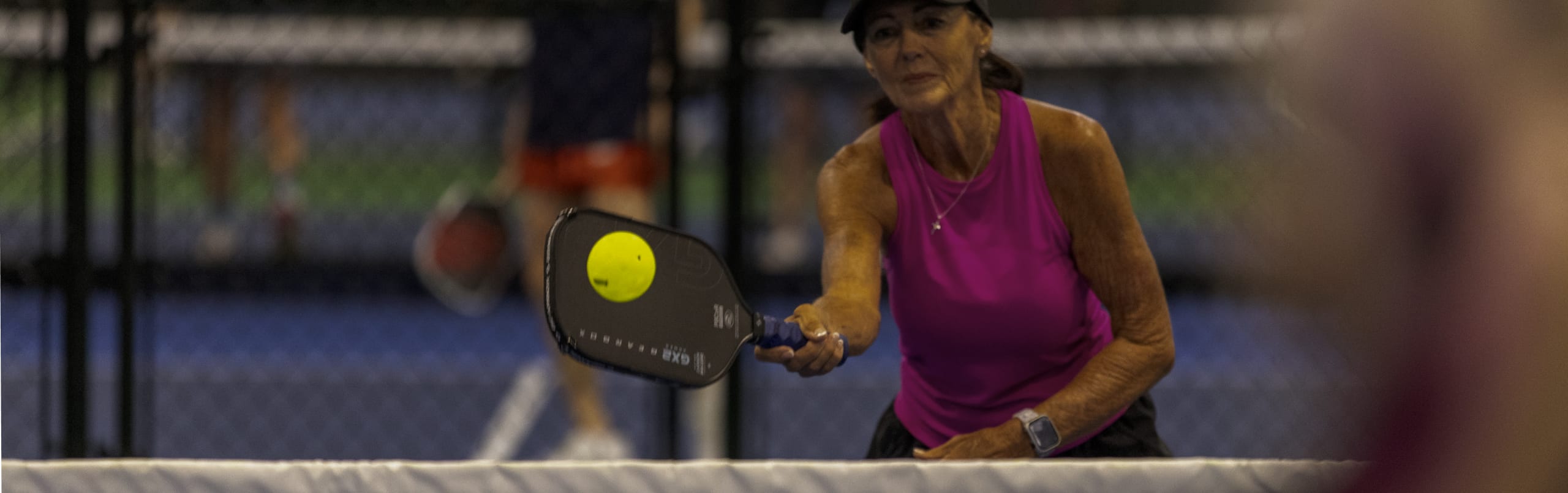 Player mid-rally on the indoor courts